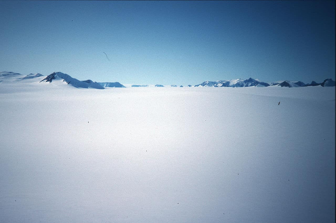 The high, flat, and cold environment of the Antarctic Plateau at Dome C