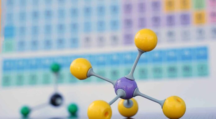 Carbon is a chemical element of the periodic table. Symbol for the chemical element carbon with atomic data (atomic number, mass and electron configuration) and graphite pencils in the background.