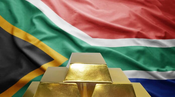 brillanti lingotti d'oro sullo sfondo della bandiera del sud africa