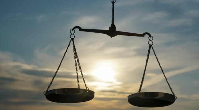 Fondo della bilancia della giustizia - concetto di diritto legale.  una bilancia è tenuta in mano, il cielo è lo sfondo. Segno zodiacale - Bilancia