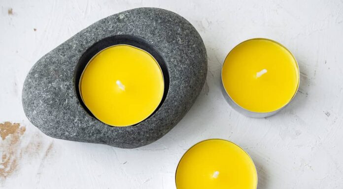 Candele anti-zanzara alla citronella su sfondo rustico bianco