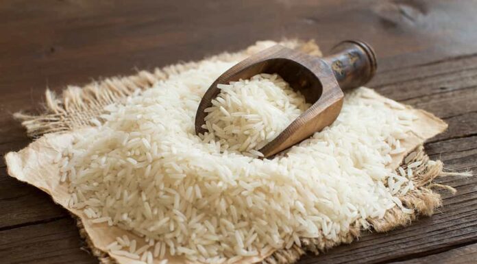 Mucchio di riso Basmati crudo con un cucchiaio
