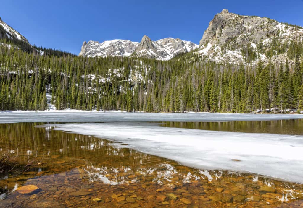 Fern Lake mezzo congelato con montagne sullo sfondo