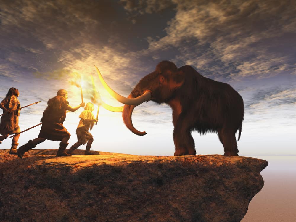 Illustrazione 3d di uomini preistorici che cacciano un giovane mammut