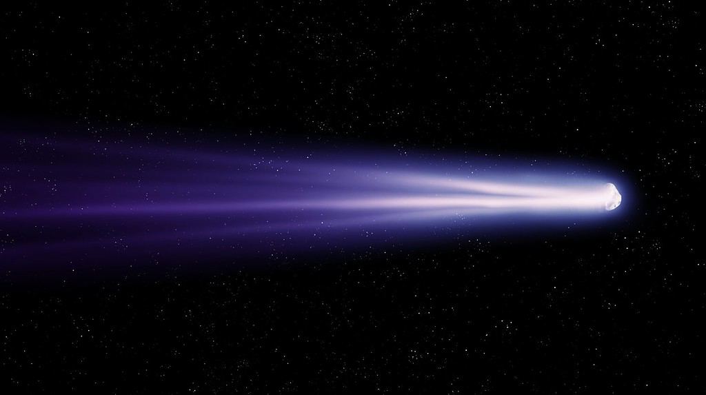 Cometa con una lunga coda luminosa nello spazio.  Osservazione di oggetti astronomici.  Foto di una vera cometa che vola vicino alla Terra.
