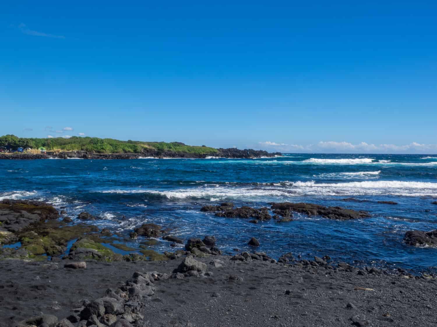 Punaluu Beach ha sabbia nera fatta di basalto e creata dalla lava che scorre nell'oceano che esplode quando raggiunge l'oceano e si raffredda.