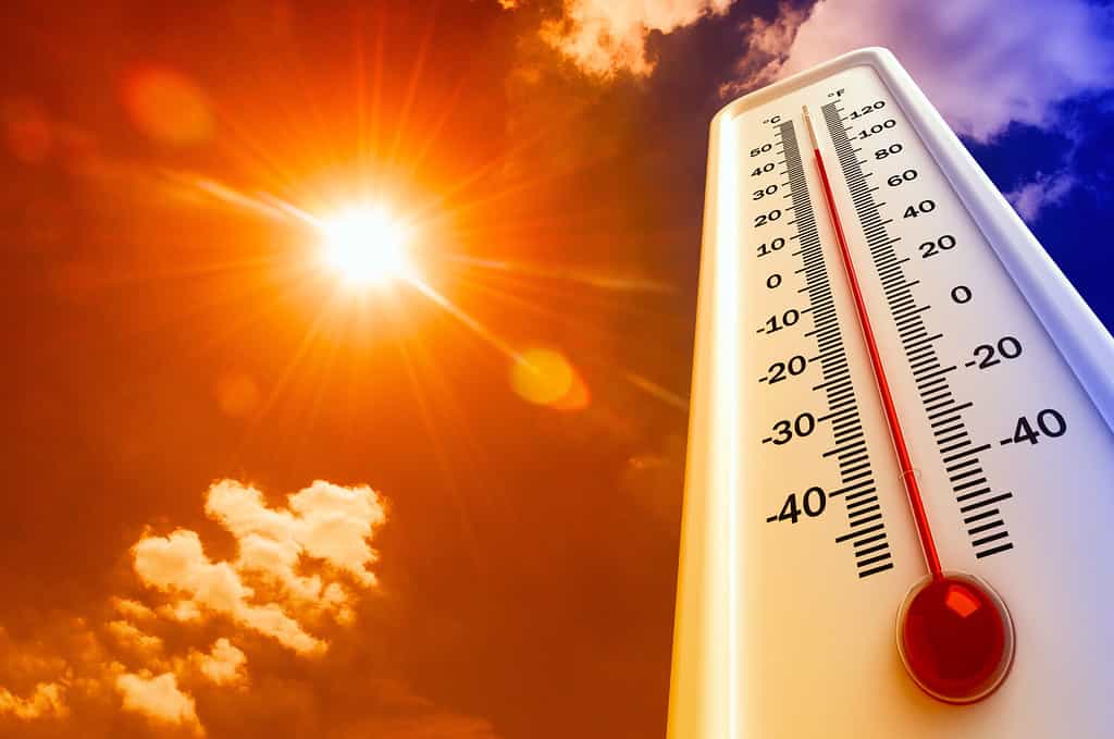 Calore, il termometro mostra che la temperatura è calda nel cielo, estate