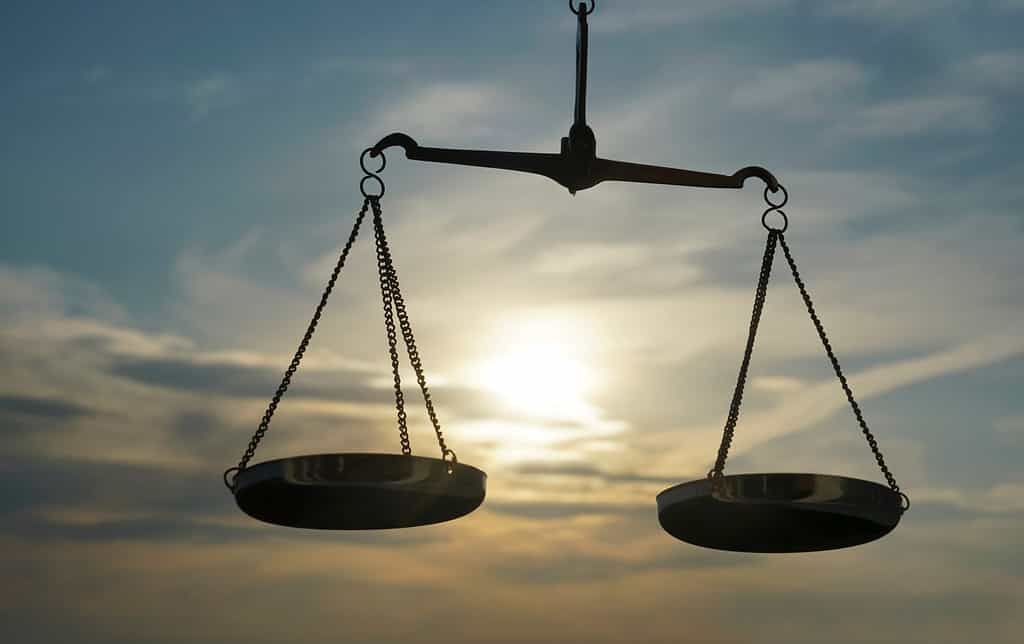 Fondo della bilancia della giustizia - concetto di diritto legale.  un equilibrio è tenuto in mano, il cielo è il segno background.zodiac - libra