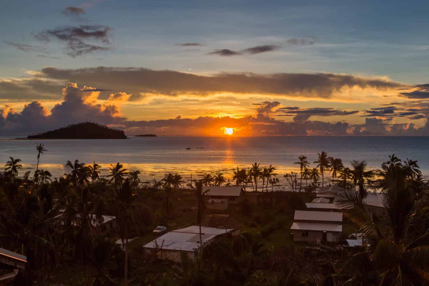 La mattina presto e l'alba sull'Oceano Pacifico nel villaggio di Mata-Utu, la capitale del territorio di Wallis e Futuna (Wallis et Futuna), collettività di isole francesi d'oltremare.  Il centro è ricoperto di palme.