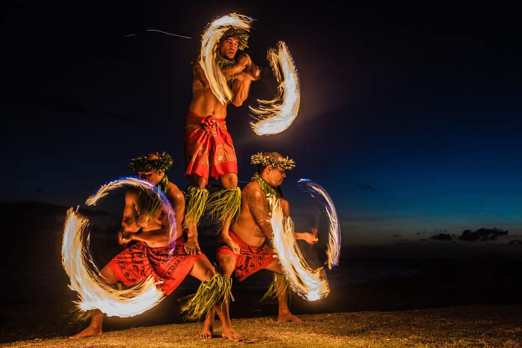 Tre uomini forti che si destreggiano con il fuoco alle Hawaii - Danzatori di fuoco