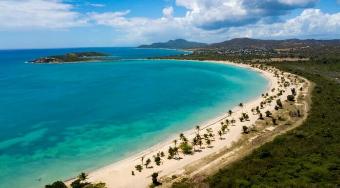 Bella spiaggia di Sun Bay con piccole barche da pesca e gente che si rilassa situata sull'isola tropicale caraibica di Vieques Puerto Rico