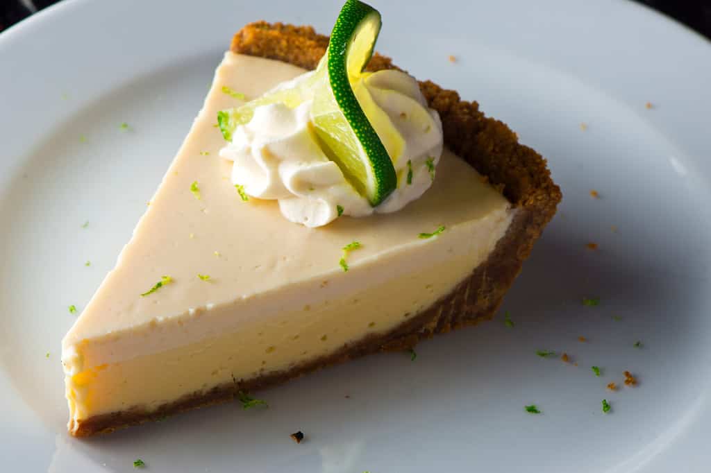 Torta al lime chiave.  Il classico dessert americano tradizionale preferito.  Torta al lime di Key, miscela cruda fatta con il succo del succo di lime di Key West, zucchero del latte condensato e uova versate nella crosta di cracker Graham.