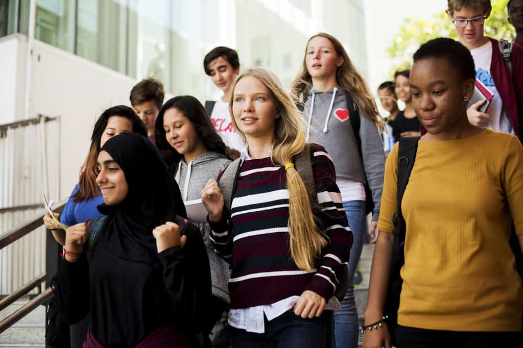 Gruppo di compagni di scuola che camminano giù per le scale