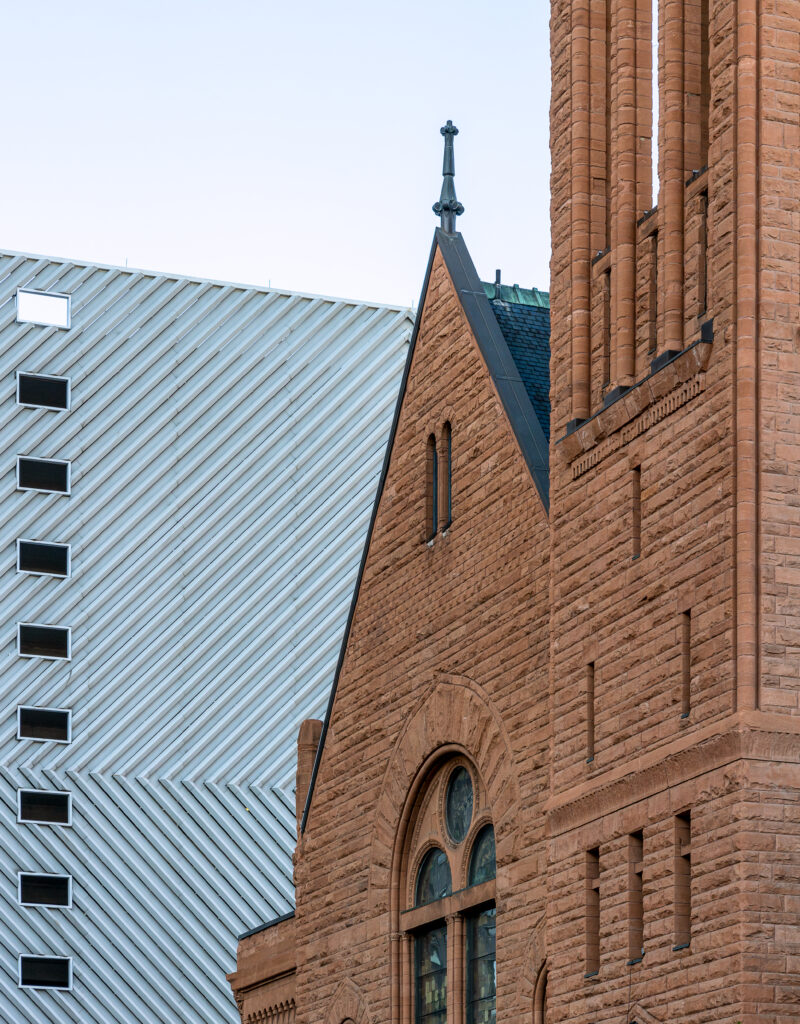 Storica chiesa presbiteriana centrale in mattoni di fronte a un edificio moderno a Denver