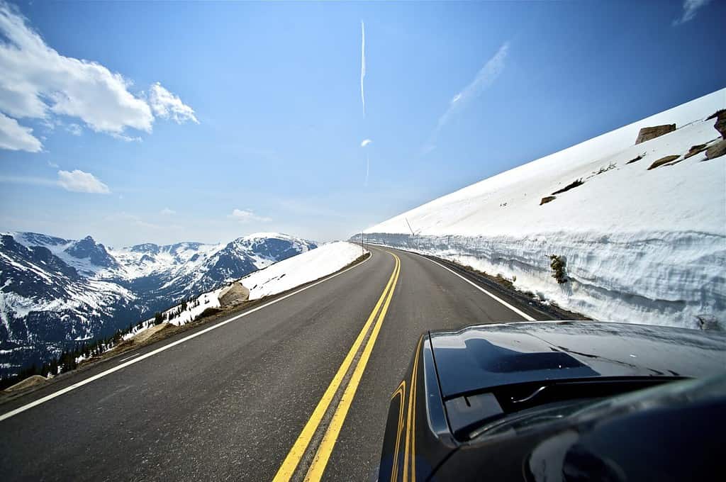 Percorrendo la strada della montagna del Colorado.  Tanto sole e neve.  Strada pulita e asciutta.  Paesaggio delle montagne.