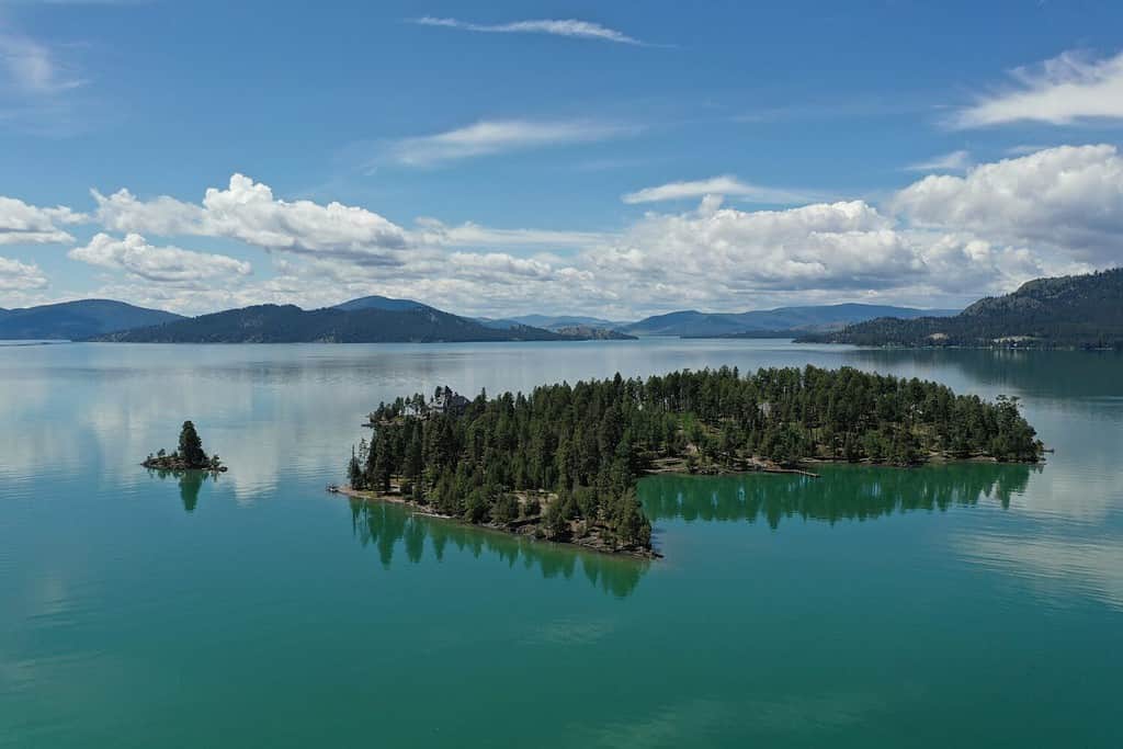 Veduta aerea di isole e montagne lontane nel lago Flathead, Montana, in una tranquilla mattinata estiva.