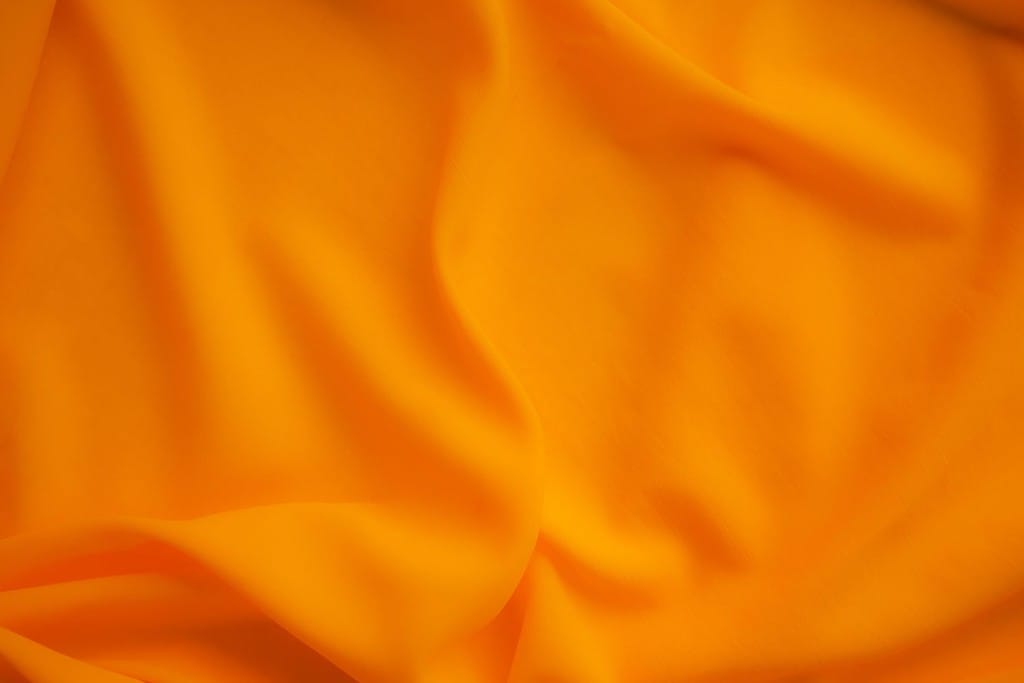 Sfondo di stoffa arancione, trama di tessuto con motivi di colore oro, sfondo di lusso con sfumature di seta, materiale per banner in tessuto giallo chiaro, motivo di onde tropicali estive in raso, modello di poster di design astratto di moda