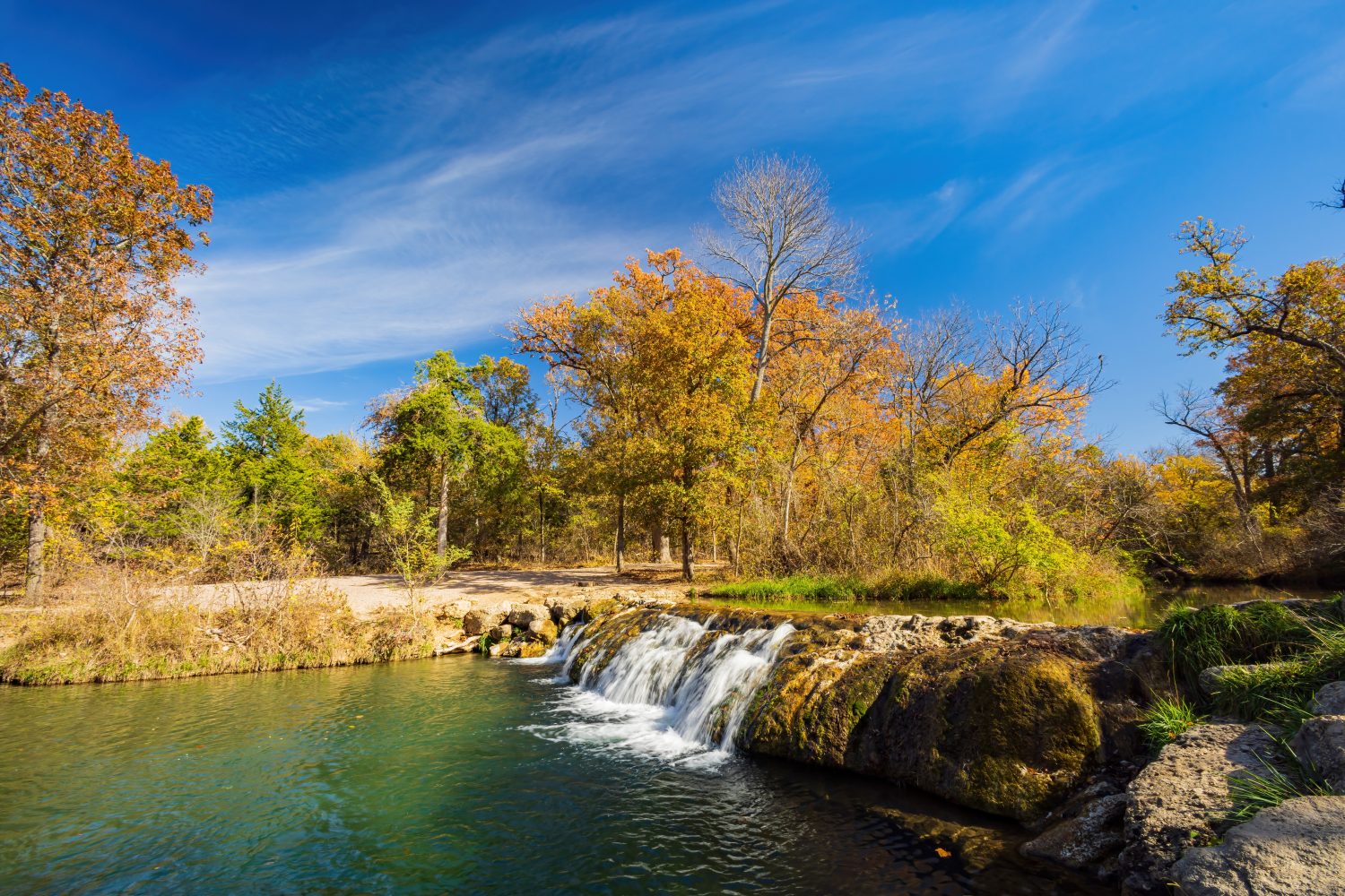 Vista soleggiata delle piccole cascate del Niagara dell'area ricreativa nazionale di Chickasaw in Oklahoma