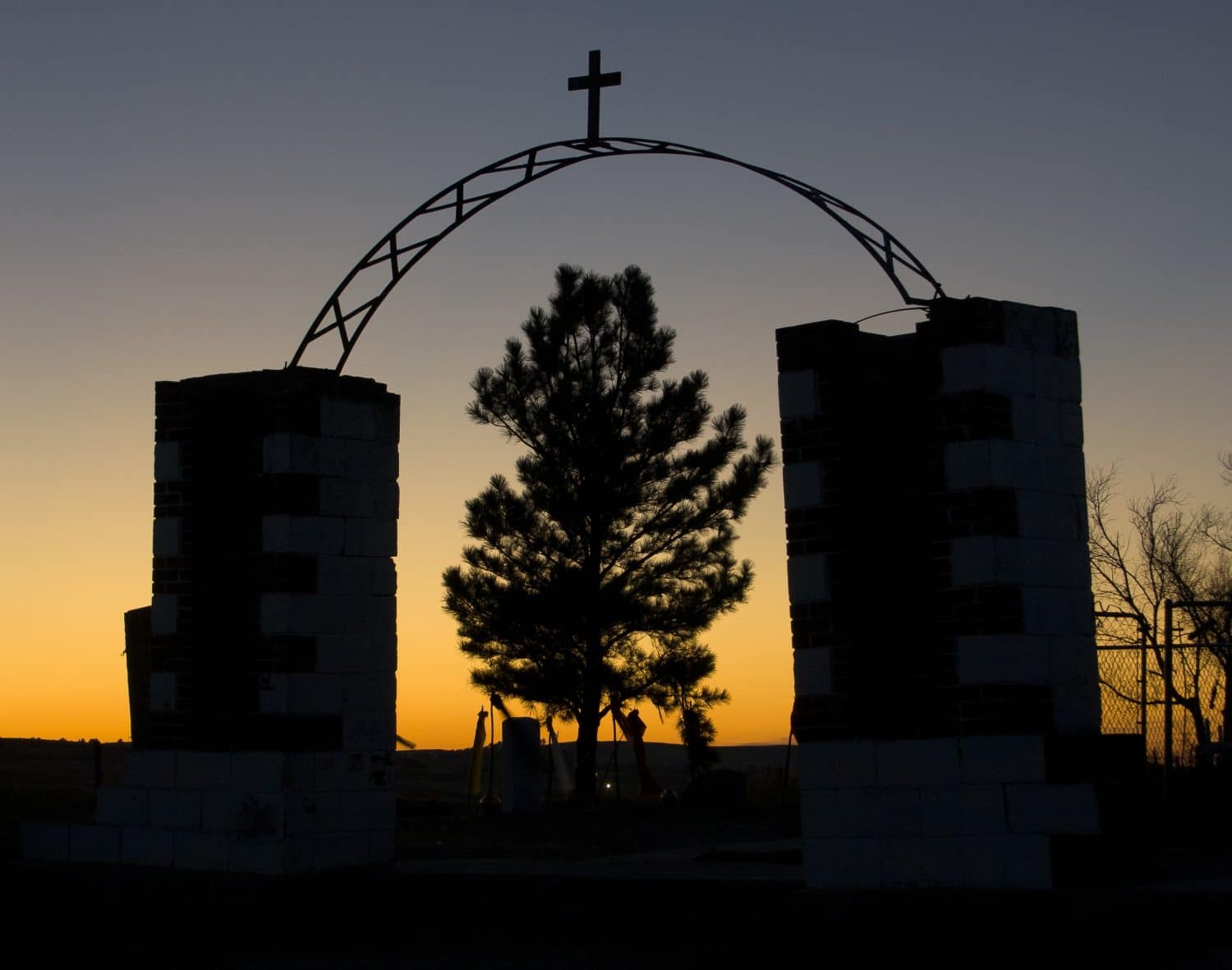 La silhouette dell'ingresso al Monumento al massacro di Wounded Knee nel South Dakota al tramonto