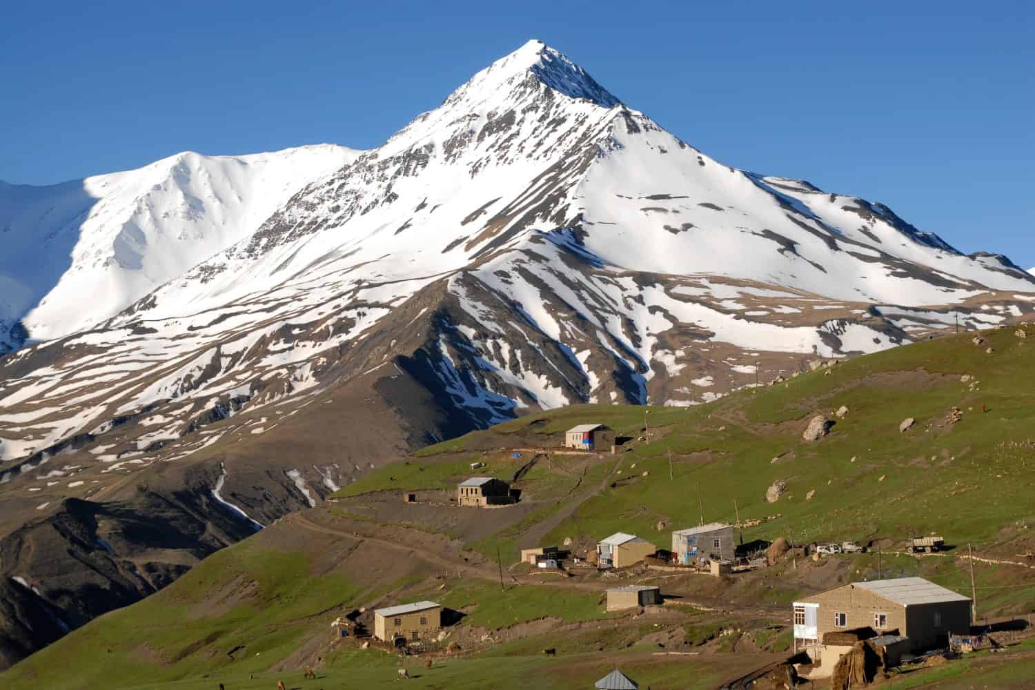 Villaggio di Kurush (il punto più meridionale della Russia e l'insediamento montano più alto d'Europa, 2560 m) e il monte Bazarduzu (4.467 m, la vetta più alta dell'Azerbaigian).  Daghestan, Caucaso settentrionale, Russia.