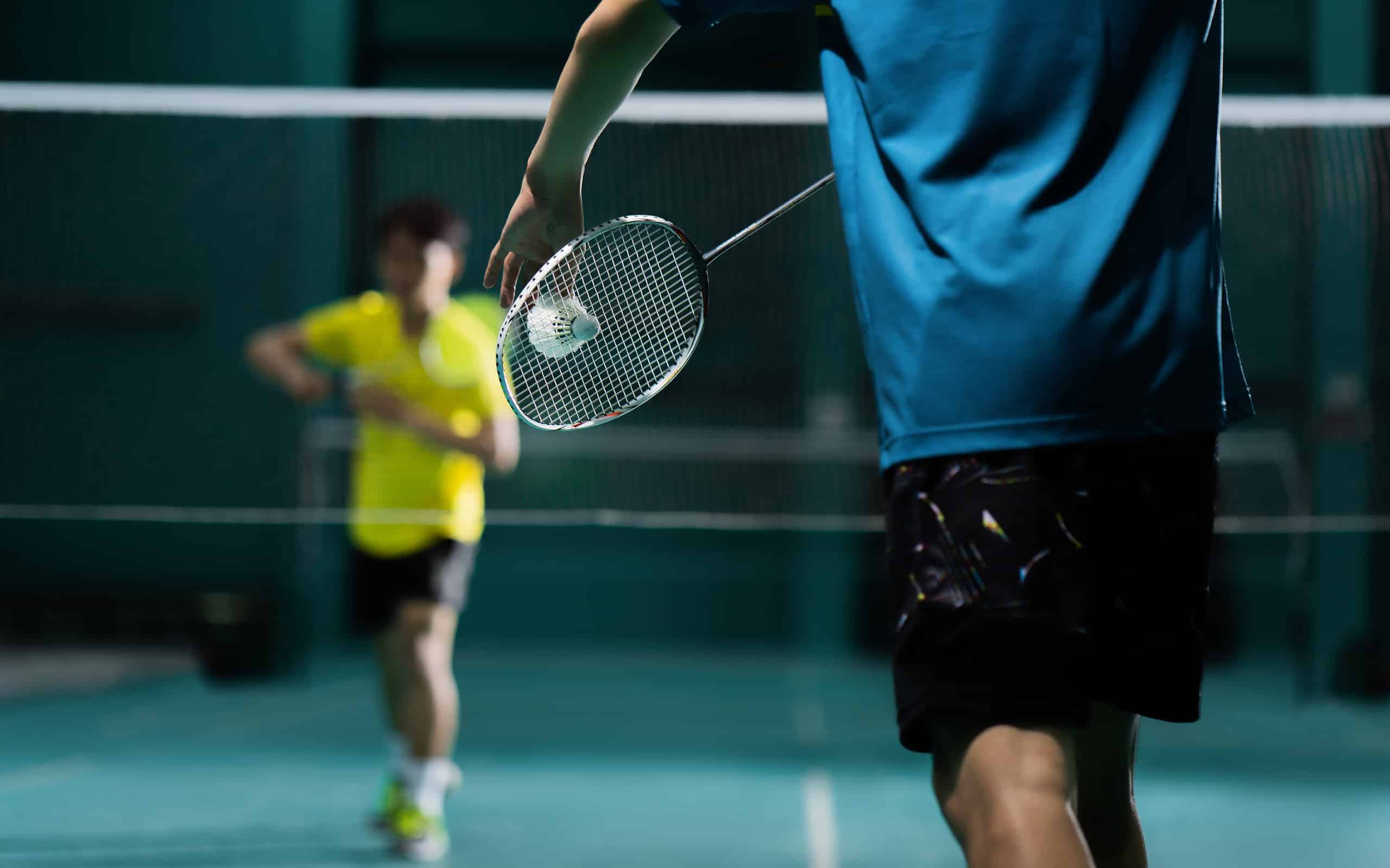 Giocatori di badminton impegnati in una partita.