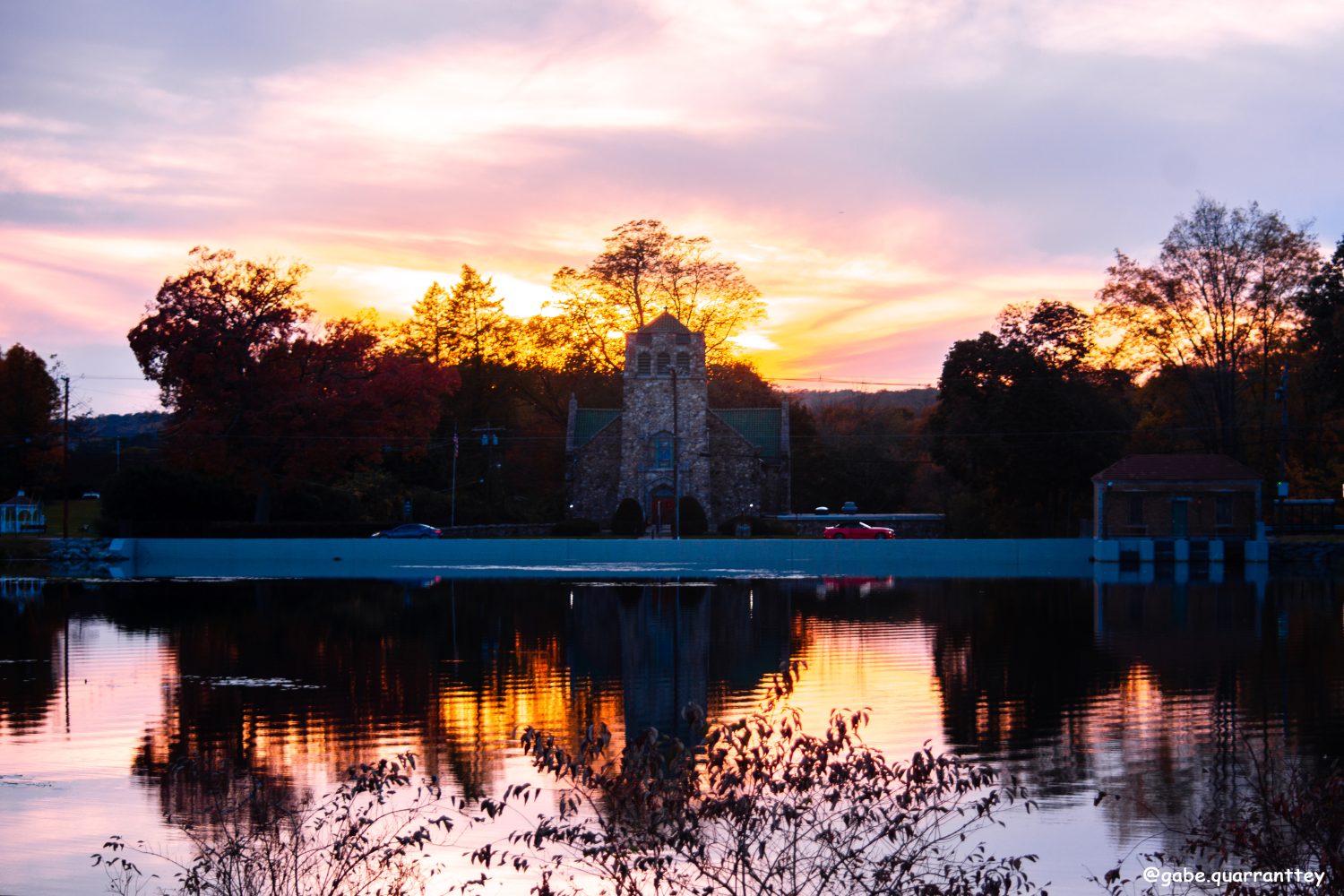 Bellissima alba rosa con vista sulla chiesa sul lago Musconetcong