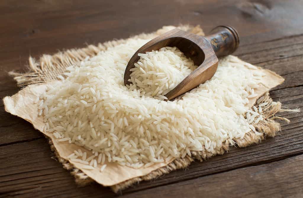Mucchio di riso Basmati crudo con un cucchiaio